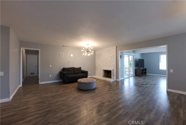 26376 Mahaffey, Menifee, CA 92586 - living area featuring dark wood-type flooring, a chandelier, and a brick fireplace