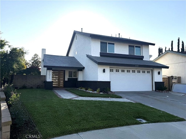 traditional home featuring concrete driveway, an attached garage, stucco siding, and fence