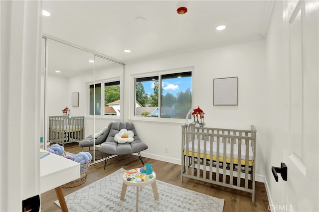 21011 N Hampton Way, Lake Forest, CA 92630 - bedroom featuring a nursery area, wood finished floors, baseboards, and recessed lighting