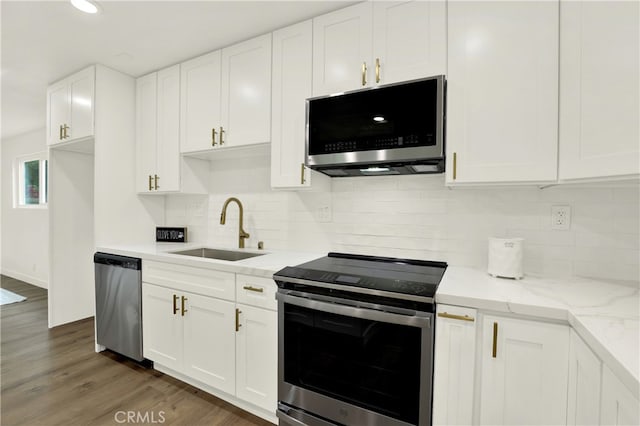 21011 N Hampton Way, Lake Forest, CA 92630 - kitchen featuring stainless steel appliances, a sink, white cabinets, dark wood-style flooring, and backsplash