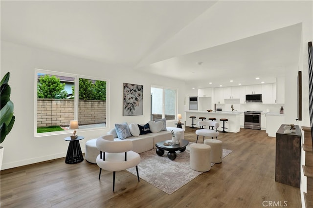 21011 N Hampton Way, Lake Forest, CA 92630 - living area featuring wood finished floors, vaulted ceiling, baseboards, and recessed lighting