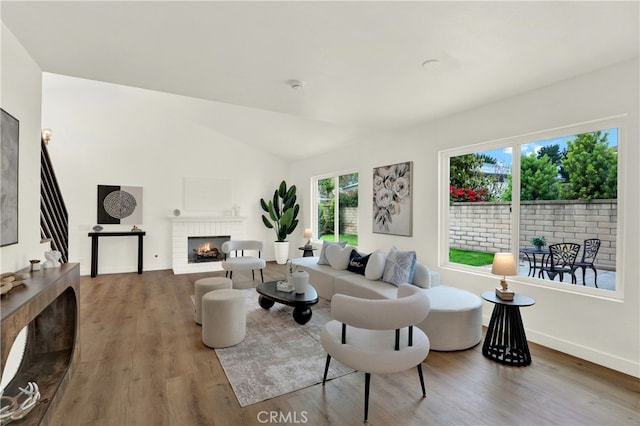 21011 N Hampton Way, Lake Forest, CA 92630 - living area featuring a brick fireplace, wood finished floors, lofted ceiling, baseboards, and stairway