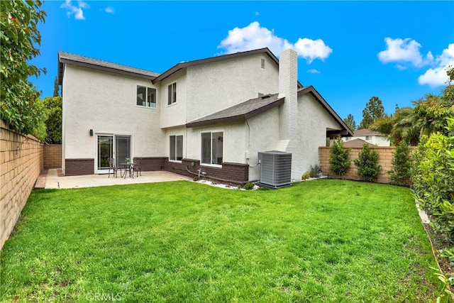21011 N Hampton Way, Lake Forest, CA 92630 - back of property featuring cooling unit, stucco siding, brick siding, a patio area, and a chimney