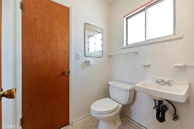bathroom featuring toilet and tile patterned floors