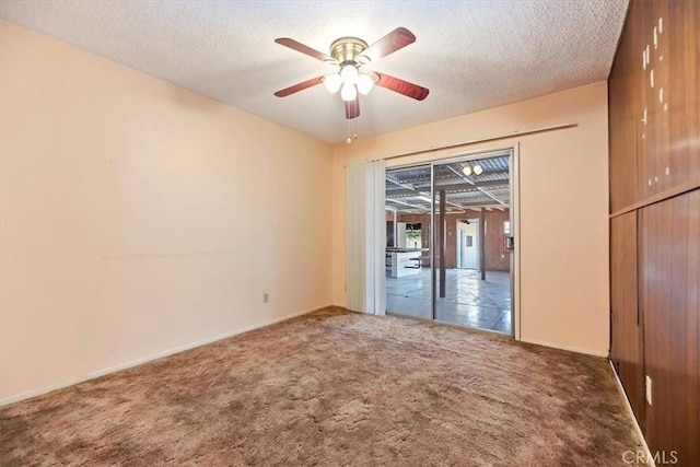 carpeted empty room with a textured ceiling and ceiling fan