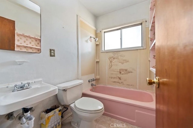 full bathroom with toilet, washtub / shower combination, tile patterned floors, and a sink