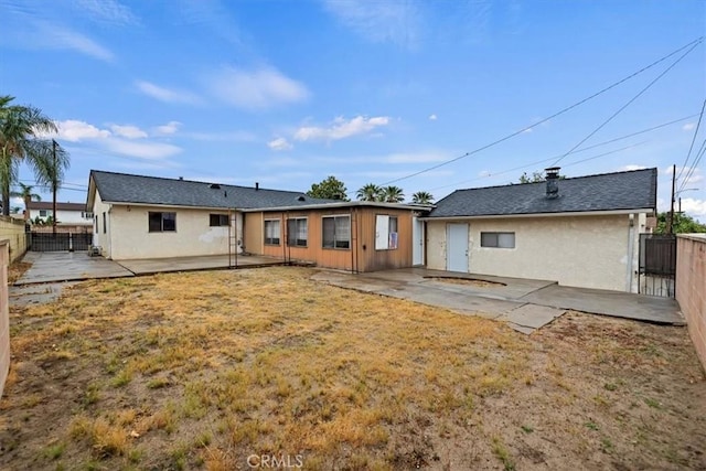 rear view of property with a patio area, stucco siding, and a fenced backyard