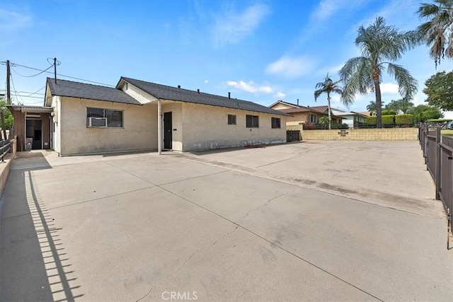single story home featuring stucco siding, fence, and a patio