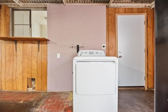 washroom with washer / dryer, laundry area, and wooden walls