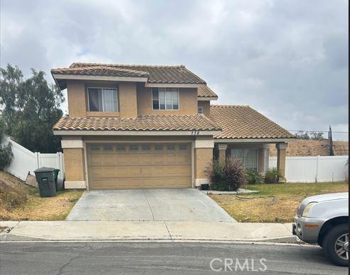 778 La Cumbre St, Corona, CA 92879 - mediterranean / spanish-style home featuring fence, an attached garage, driveway, a tile roof, and stucco siding