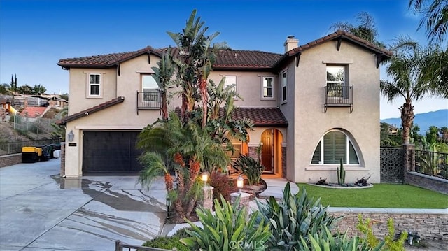 200 Cross Rail Ln, Norco, CA 92860 - mediterranean / spanish home featuring a balcony, a tiled roof, concrete driveway, and an attached garage