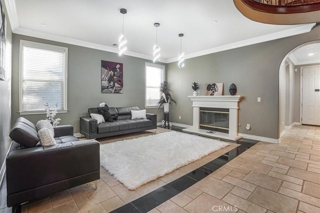 200 Cross Rail Ln, Norco, CA 92860 - living area with arched walkways, baseboards, ornamental molding, a glass covered fireplace, and stone tile flooring