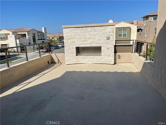 view of patio featuring a balcony and a residential view