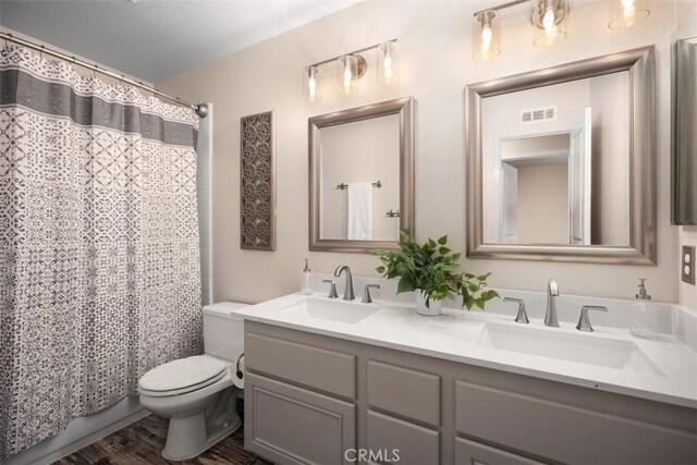 15 Saltillo, Rancho Santa Margarita, CA 92688 - full bathroom featuring toilet, double vanity, and wood finished floors
