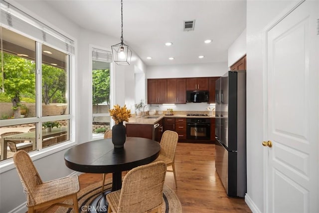 15 Saltillo, Rancho Santa Margarita, CA 92688 - kitchen with black appliances, light wood-type flooring, pendant lighting, light countertops, and recessed lighting