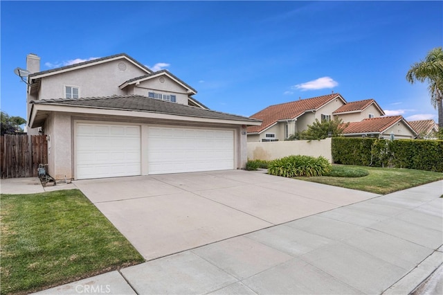 view of front of home with fence, driveway, a garage, stucco siding, and a front lawn