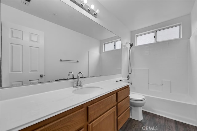full bathroom with vanity, toilet, a healthy amount of sunlight, and wood finished floors
