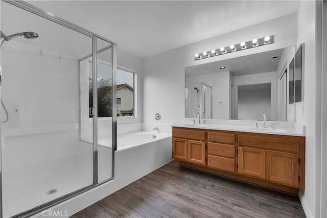 full bathroom featuring double vanity, a stall shower, and a sink