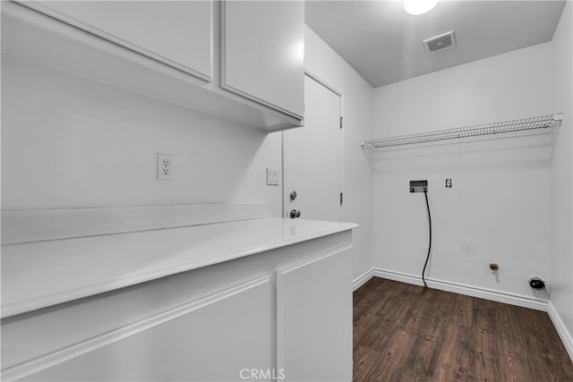 laundry room with cabinet space, washer hookup, visible vents, dark wood-style flooring, and baseboards