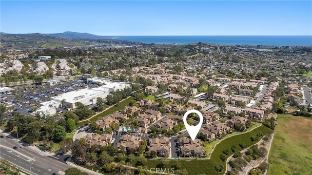 drone / aerial view with a water view and a residential view