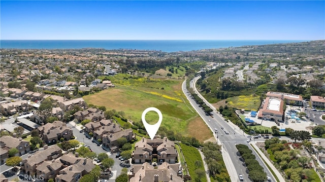 birds eye view of property featuring a water view and a residential view