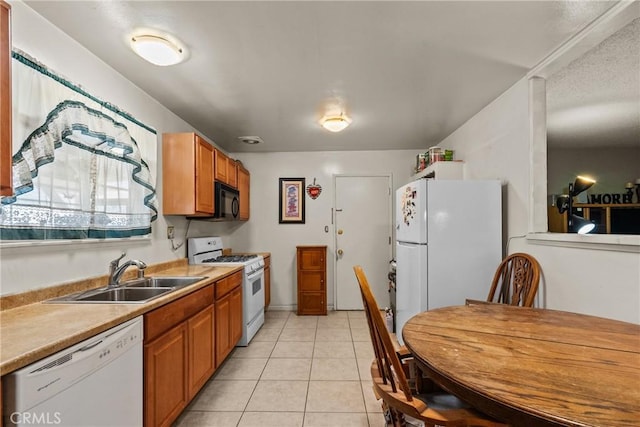 1572 Fremont Ave, Simi Valley, CA 93065 - kitchen with white appliances, a sink, light countertops, brown cabinets, and light tile patterned flooring