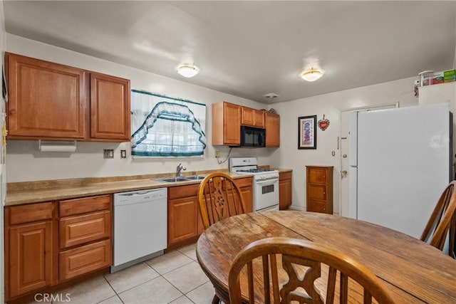 1572 Fremont Ave, Simi Valley, CA 93065 - kitchen with white appliances, a sink, brown cabinets, light tile patterned floors, and light countertops