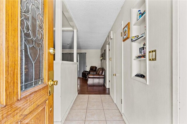 1572 Fremont Ave, Simi Valley, CA 93065 - hallway featuring light tile patterned flooring and a textured ceiling