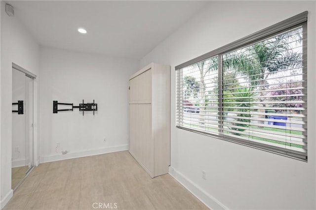 interior space with light wood-type flooring, baseboards, and recessed lighting