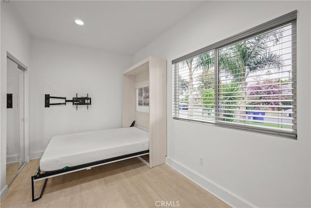 bedroom featuring baseboards, multiple windows, recessed lighting, and light wood-type flooring