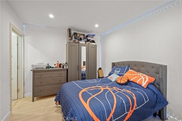 bedroom featuring wood finished floors and recessed lighting