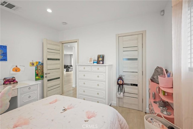 bedroom with recessed lighting, light wood finished floors, and visible vents