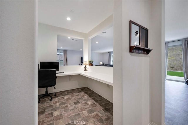 office area with baseboards, recessed lighting, and stone finish floor