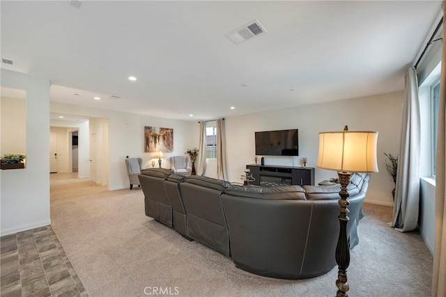 living room with light colored carpet, visible vents, baseboards, and recessed lighting