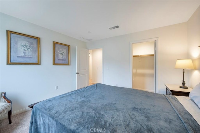 bedroom featuring baseboards, visible vents, and carpet
