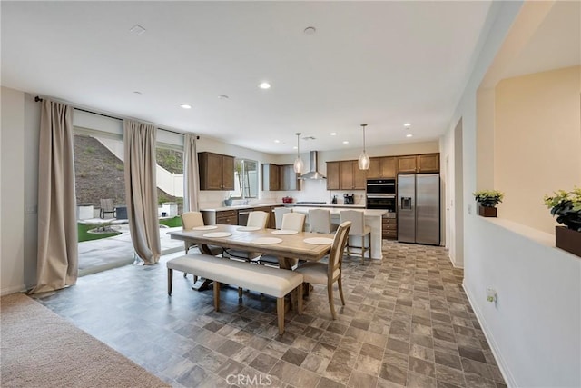 dining room with baseboards, stone finish flooring, and recessed lighting