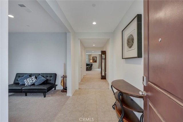 corridor with recessed lighting, light tile patterned floors, baseboards, visible vents, and light carpet