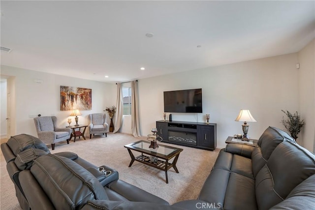carpeted living area with visible vents and recessed lighting