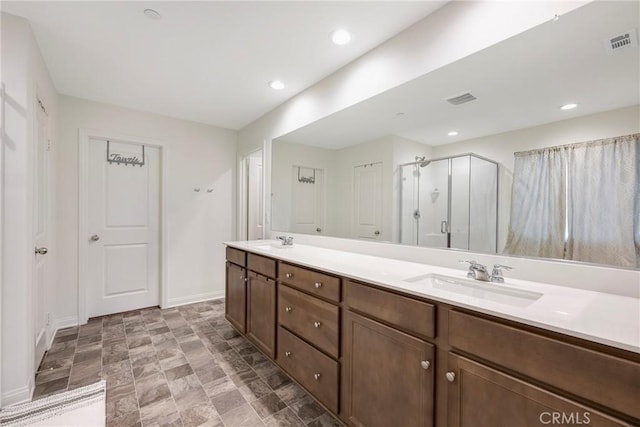 bathroom with a sink, baseboards, and visible vents