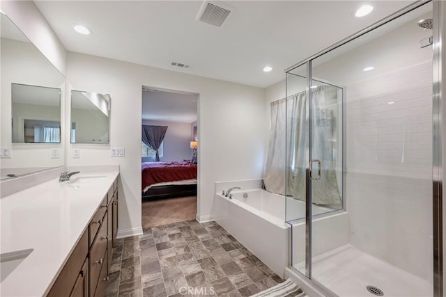 full bath with a shower stall, connected bathroom, visible vents, and double vanity