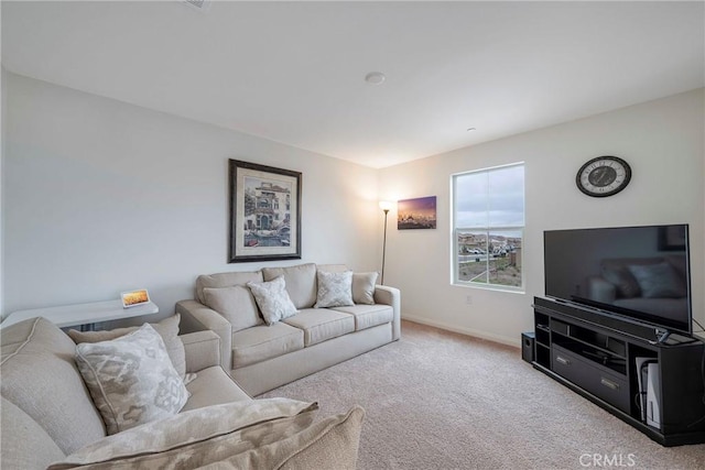 living area featuring carpet floors and baseboards