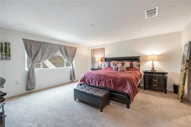 bedroom with carpet, visible vents, and baseboards