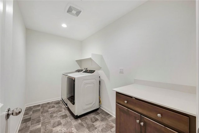 washroom with washing machine and clothes dryer, baseboards, stone finish flooring, and recessed lighting
