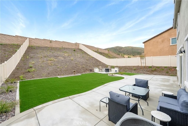 view of patio / terrace featuring a fenced backyard and a mountain view