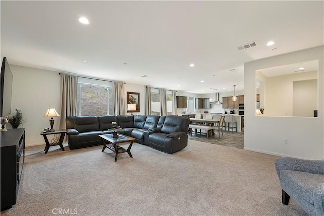 living room featuring light colored carpet, baseboards, visible vents, and recessed lighting