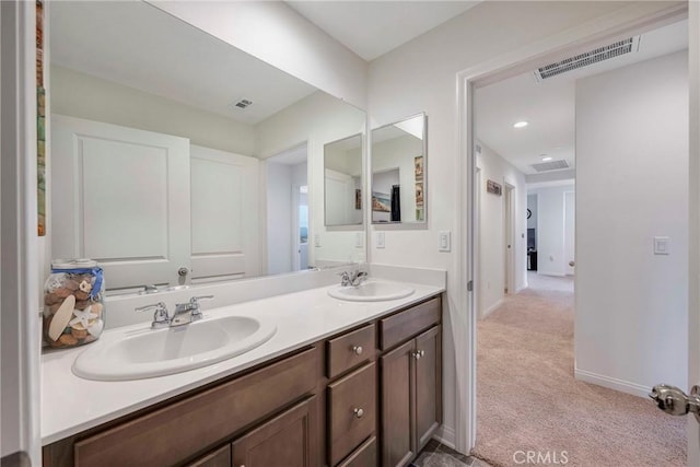 bathroom featuring a sink, double vanity, and visible vents