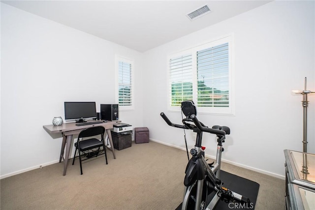 office area featuring carpet floors, baseboards, and visible vents