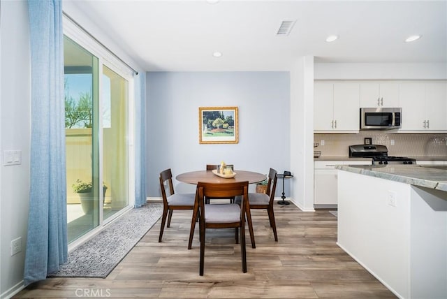 interior space featuring light wood-type flooring, visible vents, and recessed lighting