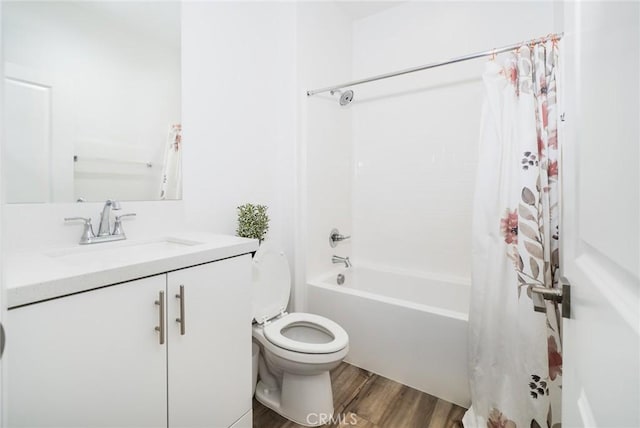 bathroom featuring toilet, wood finished floors, vanity, and shower / bathtub combination with curtain