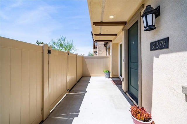 view of patio with fence and a gate